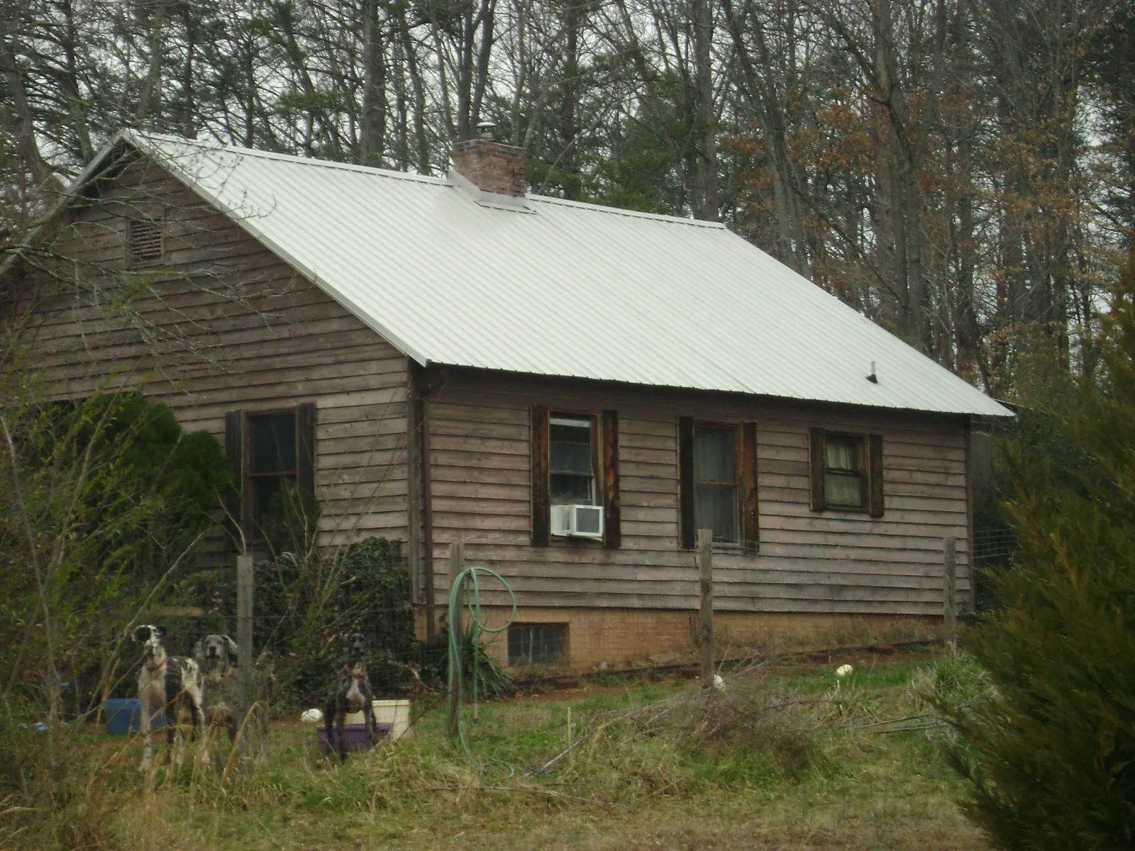White metal roof on an old wood sided farmhouse, from a Metal Roof Installation job in Kirkville